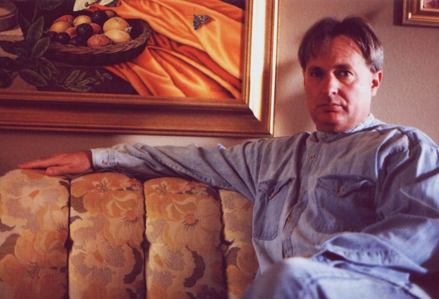 Ron sitting on his living room couch.